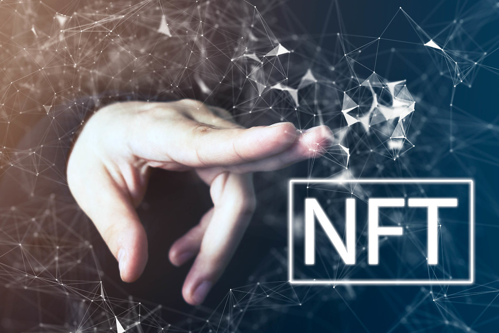 NFT sign being pointed at through technological web