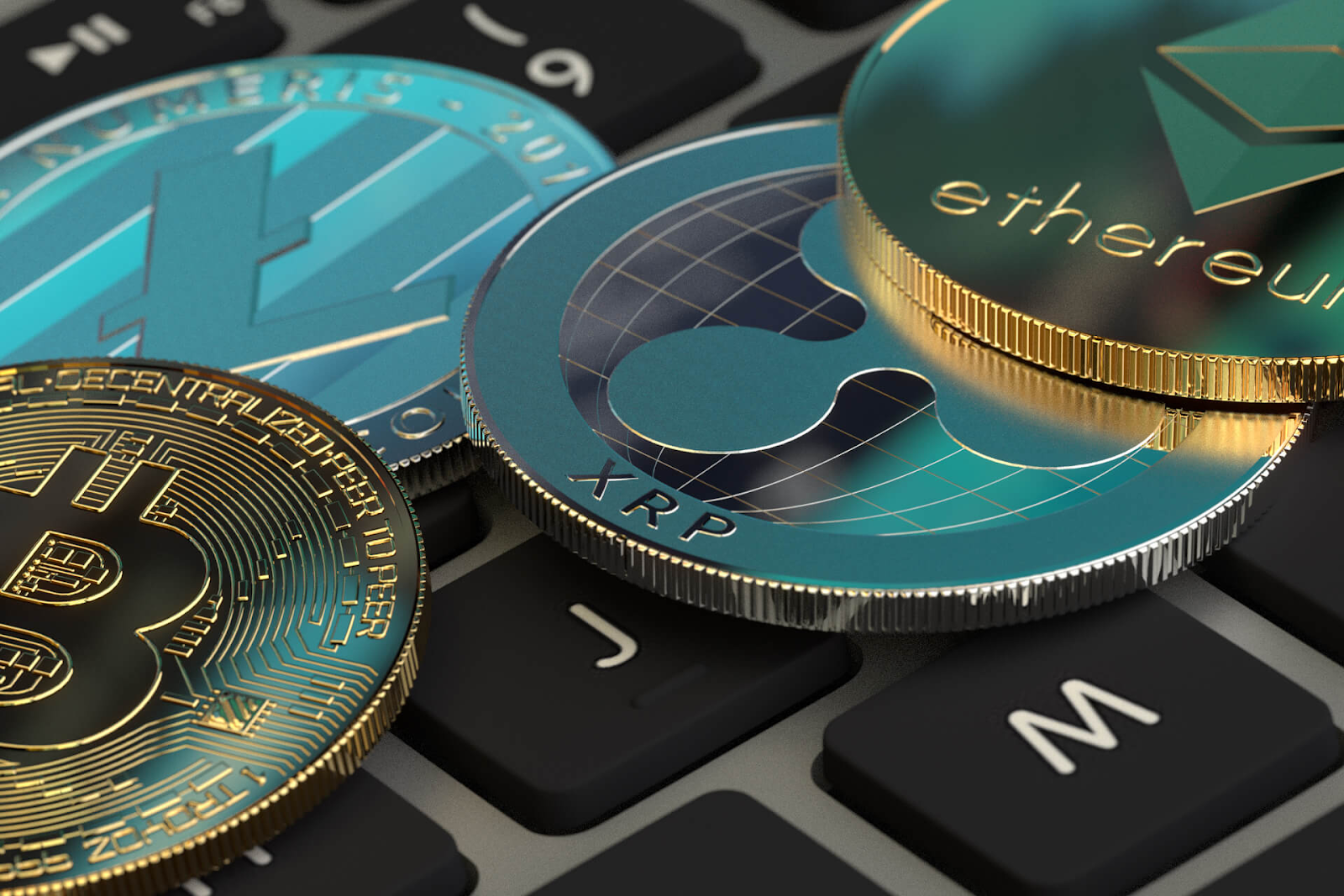 bitcoin coin, ethereum coin,xrp coin on keyboard