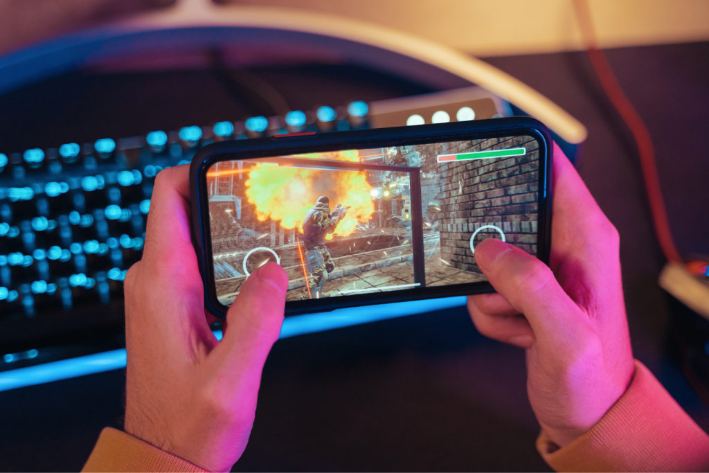 Someone playing a shooter game on smartphone