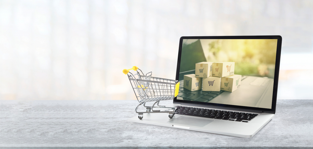image of a laptop along with a shopping cart on the side
