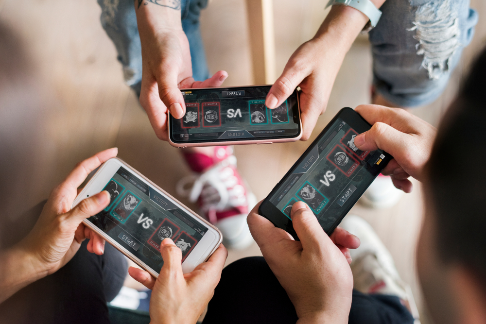 image showing three people playing a mobile online game together