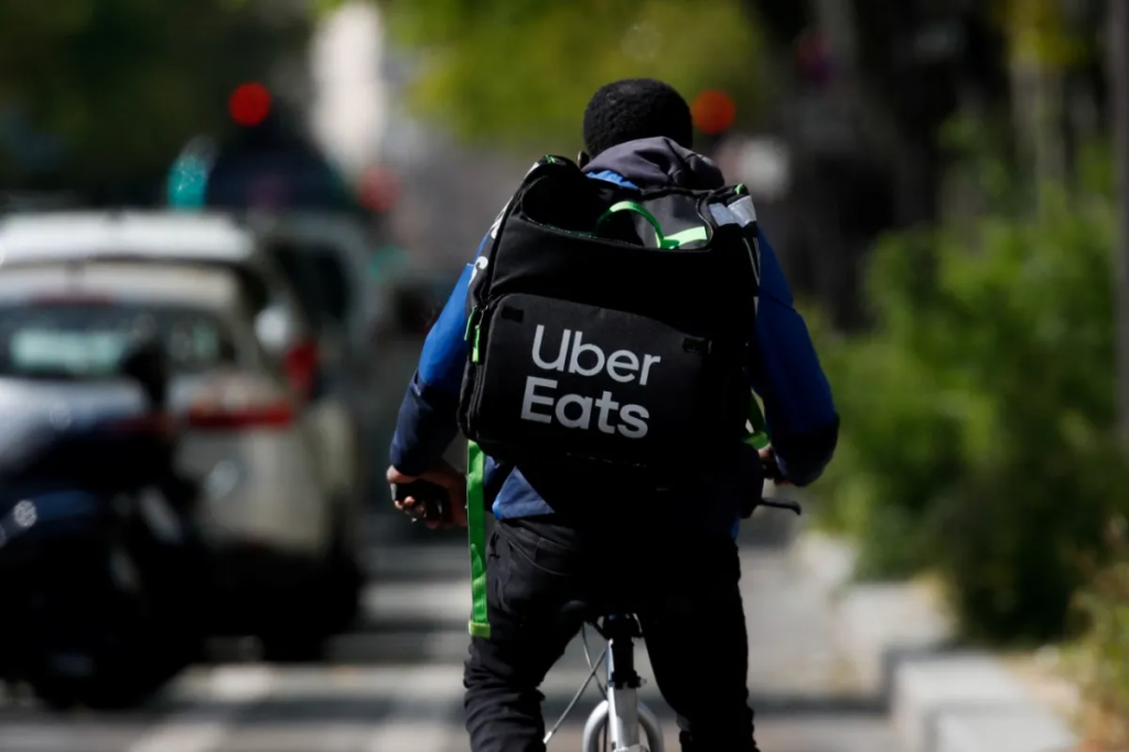 image showing a person delivering food using an Uber Eats backpack